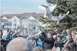  ?? ANDREW VAUGHAN, CP ?? Doves are released at Wednesday’s funeral for Rebecca Schofield at Immaculate Heart of Mary Catholic Church in Riverview, N.B.