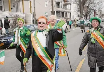  ?? Phoebe Sheehan / Times Union archive ?? North Albany Limerick Parade marshal Diane Maguire waves at the crowd during the 2019 Saint Patrick's Day parade in Albany. This year’s version will start at 11:30 a.m. Saturday.