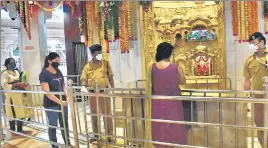  ?? ANSHUMAN POYREKAR/HT PHOTO ?? A day after places of worship across the state reopened after eight months, devotees follow social distancing norms at Siddhivina­yak temple in Prabhadevi on Tuesday.