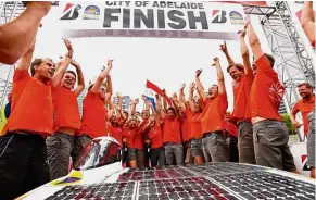  ??  ?? The winning team: Members of the Nuon Solar team celebratin­g after winning the 2017 World Solar Challenge after crossing the finish line in Adelaide. — Reuters