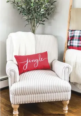  ??  ?? (top) The blanket ladder in the living room is another way that Jenna brings in a pop of red. The ladder is normally filled with blankets of more neutral tones, but Jenna replaces one of them with a red-and-green plaid blanket that gives the corner a subtle Christmas feeling.