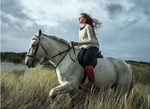  ??  ?? Wild at heart: Joanna Mackay rides an Eriskay pony at Luskentyre beach