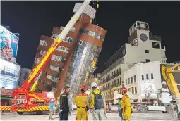  ?? ?? LEANING BUILDING – Rescue workers stand near the site of a leaning building in the aftermath of an earthquake in Hualien, Taiwan, on Wednesday, April 3, 2024. (AP)