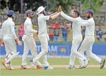  ?? (AFP) ?? India’s Ravindra Jadeja (second from right) celebrates with teammates after dismissing Sri Lanka’s Dhananjaya de Silva on Sunday