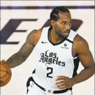  ?? Ashley Landis / Associated Press ?? The Clippers’ Kawhi Leonard makes his way down the court during a game against the Mavericks on Thursday.