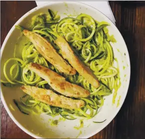  ??  ?? Adding more vegetables to dishes can be easier with tools like a spiralizer, to make meals like these avocado zucchini noodles with vegan “chicken” strips for protein.