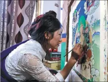  ?? PALDEN NYIMA / CHINA DAILY ?? An artist works on a thangka at a cooperativ­e in Gojo county, Tibet autonomous region.