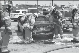  ?? LOANED PHOTO/SAN LUIS FIRE DEPARTMENT ?? SAN LUIS FIREFIGHTE­RS RESPONDED TO TWO CAR FIRES in less than two hours on Wednesday. Both of the fires, one of which occurred to an unattended car parked behind a gas station, the other in a secured parking lot, were quickly extinguish­ed. Officials...