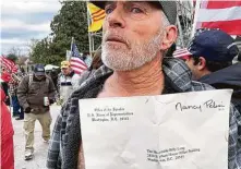  ?? Matthew Rosenberg / New York Times ?? Richard Barnett, 60, of Gravette, Ark., shows the envelope he took from House Speaker Nancy Pelosi’s office at the Capitol.