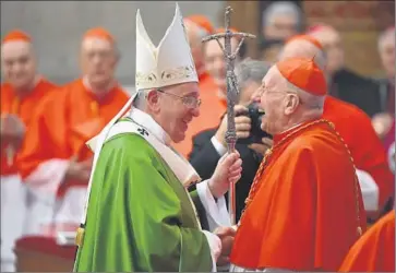  ?? Gabriel Bouys
AFP/ Getty Images ?? POPE FRANCIS, left, greets French Cardinal Roger Etchegaray at the end of the Mass at St. Peter’s Basilica at the Vatican. The evening before, Francis urged synod participan­ts to listen to “the call of the people.”