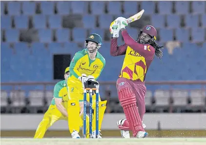  ?? AFP ?? West Indies’ Chris Gayle, right, in action during a T20 internatio­nal against Australia in July.