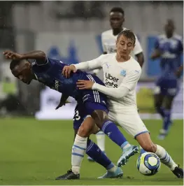  ?? — AP ?? Marseille’s Valentin Rongier (right) duels for the ball with Strasbourg’s Lionel Carole during the French League One match in Marseille on Sunday.