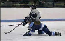  ?? STUART CAHILL — BOSTON HERALD ?? Peabody’s Hannah Gromyko tries to defend against Gabbi Oakes of St. Mary’s as she skates toward the net. St. Mary’s earned a 2-0 state tournament win.