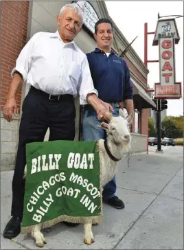  ?? Ap pHoto ?? Billy Goat Tavern owners Sam Sianis, left, and his son Bill pose with “Billy” the goat outside their tavern on Madison Street in Chicago. In 1945, Sam’s uncle, William, cast a curse over the Chicago Cubs for not letting him bring his billy goat into...