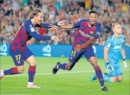  ?? AP ?? Barcelona's Ansu Fati (centre) celebrates with teammate Antoine Griezmann after scoring the opening goal during the La Liga match against Valencia at the Camp Nou.