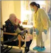  ?? The Canadian Press ?? A personal support worker helps a resident in an assisted living program in Toronto.