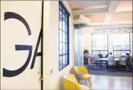  ?? Tyler Sizemore / Hearst Connecticu­t Media ?? Employees talk at a conference table in the redesigned interior of Granoff Architects’ offices on the first floor of 330 Railroad Ave. in Greenwich last week.