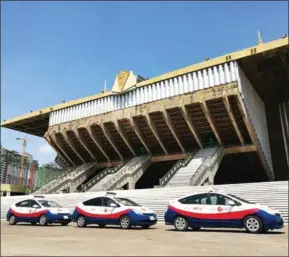  ?? SUPPLIED ?? Three Phnom Penh Automobile taxis parked in front of Olympic Stadium in Phnom Penh yesterday.