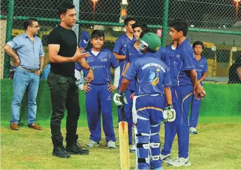  ?? Courtesy: Saleem Sanghati ?? Mahendra Singh Dhoni interacts with young cricketers during the launch of the MS Dhoni Cricket Academy at the Springdale­s School on Sunday. The Indian star had a session with the kids on Sunday before flying out early yesterday.