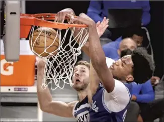  ?? Robert Gauthier Los Angeles Times ?? DAMIAN JONES dunks over Minnesota’s Jake Layman in the first quarter at Staples Center. The young center, playing on a second 10-day contract, has been aggressive early in games.