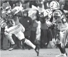  ?? Ed Zurga/Associated Press ?? ■ Kansas City Chiefs wide receiver Tyreek Hill (10) gestures as he runs past Indianapol­is Colts safety Clayton Geathers (26) and linebacker Anthony Walker on Saturday in Kansas City, Mo. The Chiefs defeated the Colts, 31-13, will play the New England Patriots for the AFC title.