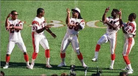  ?? ASSOCIATED PRESS ?? Ickey Woods (center) and teammates do their dance for the media Jan. 17, 1989, at Super Bowl Media Day in Miami. The Bengals lost the game to the 49ers.