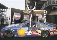  ?? Chris Graythen / Getty Images ?? Kevin Harvick celebrates after winning the NASCAR Cup Series Big Machine Hand Sanitizer 400 at Indianapol­is Motor Speedway on Sunday.