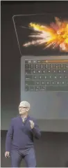  ?? AP PHOTO ?? SWIPE THIS: Apple CEO Tim Cook discusses touch-sensitive controls on the new MacBook Pro at its launch yesterday.
