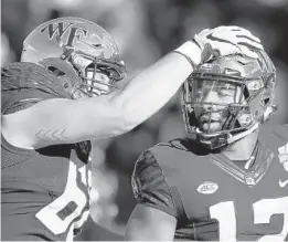  ?? JOE ROBBINS/GETTY ?? Wake Forest’s Jamie Newman. right, celebrates after scoring the game-winning touchdown against Memphis during the Birmingham Bowl Saturday.