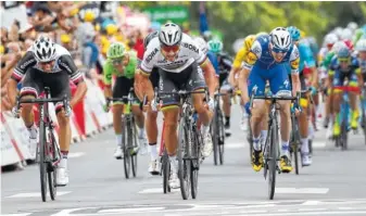  ?? THE ASSOCIATED PRESS ?? Peter Sagan of Slovakia, center, crosses the finish line ahead of second place Australia’s Michael Matthews, left, and Ireland’s Daniel Martin, to win the third stage of the Tour de France over 132 miles with start in Verviers, Belgium and finish in...