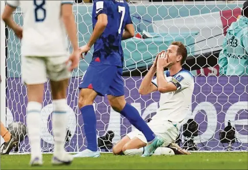  ?? Abbie Parr / Associated Press ?? England’s Harry Kane, right, gestures after missing a chance to score during a World Cup group B match against the United States at the Al Bayt Stadium in Al Khor, Qatar on Friday.
