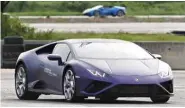  ??  ?? New models of Lamborghin­i cars, available for purchase, during a testing session for clients in Bangkok.