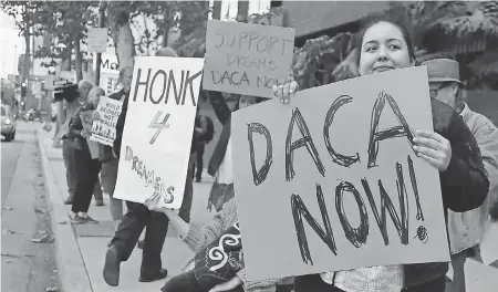  ?? REED SAXON/AP ?? Supporters of the Deferred Action for Childhood Arrivals program rally outside the office of Sen. Dianne Feinstein, D-Calif., in Los Angeles. A federal judge has blocked the Trump administra­tion’s plans to phase out the program.
