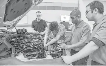  ?? Fred R. Conrad / New York Times ?? Students get hands-on instructio­n at BMW’s technician training center in Woodcliff Lake, N.J. A shortage of technician­s has become so acute that automakers like BMW have begun their own recruiting programs.