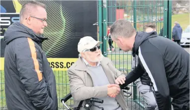  ??  ?? Life-long fan Jimmy and son Graham, left, greet ex-Thistle boss Alan Paterson before a game in 2019