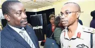  ?? RUDOLPH BROWN/PHOTOGRAPH­ER ?? National Security Minister Robert Montague (left) speaks with Rocky Meade, chief of defence staff of the Jamaica Defence Force, during the prime minister’s quarterly press briefing at Jamaica House, yesterday.