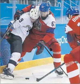  ?? MATT SLOCUM — THE ASSOCIATED PRESS ?? Brian O’Neill, left, of the United States, and the Czech Republic’s Adam Polasek battle on the boards for the loose puck in Tuesday’s eliminatio­n game.