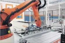  ?? SILFAB VIA THE CANADIAN PRESS ?? Robotic arms lay photovolta­ic modules for solar panels at the Silfab Solar Inc. factory in Mississaug­a.