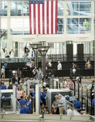  ?? DAVID ZALUBOWSKI—ASSOCIATED PRESS ?? Travelers wear face coverings in the queue for the south security checkpoint in the main terminal of Denver Internatio­nal Airport Tuesday, Aug. 24, 2021, in Denver.