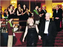  ??  ?? PIPING HOT: Nicole Bélanger and husband, honorary patron Sean Finn, are ceremoniou­sly piped in for the main dinner at the St. Patrick’s Society of Montreal’s annual charity ball.