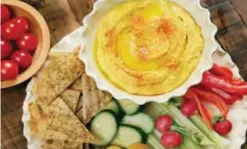  ??  ?? NEW YORK: The photo shows roasted carrot hummus with crudite and pita chips at the Institute of Culinary Education.—AP