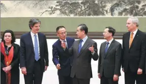  ?? FONG YONGBIN / CHINA DAILY ?? State Councilor and Foreign Minister Wang Yi talks with representa­tives of the United Nations Security Council and ministry officials in the Great Hall of the People in Beijing, on Monday.