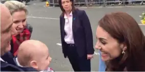  ??  ?? Cooing: Kate meets five-month-old James in Ballymena yesterday