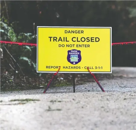  ?? NICK PROCAYLO ?? Warning signs have been posted on the trails in Stanley Park as part of a park board public education campaign on how to co-exist with coyotes after several recent reports of coyotes chasing and nipping at joggers and cyclists near Prospect Point.