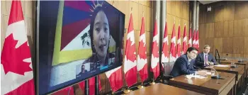  ?? ADRIAN WYLD, THE CANADIAN PRESS ?? Conservati­ve MP Garnett Genuis, left, and Pierre Paul-Hus listen to Chemi Lhamo during a news conference in Ottawa, on Thursday.