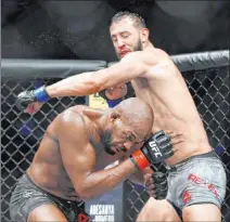  ?? Michael Wyke The Associated Press ?? Champion Jon Jones ducks from a punch by Dominick Reyes during their light heavyweigh­t bout Feb. 8 at UFC 247 in Houston.