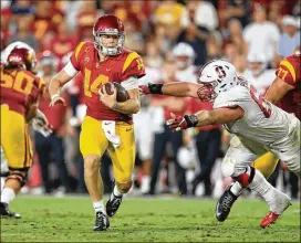  ?? SEAN M. HAFFEY / GETTY IMAGES ?? Stanford’s Harrison Phillips tries to tackle USC’s Sam Darnold in a game last year. Phillips is among the 39 players on the draft boards who carried a grade-point average of 3.2 or better throughout college.