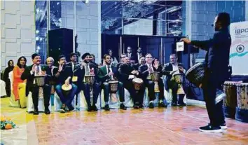  ?? Clint Egbert/Gulf News ?? Indian Consul-General Anurag Bhushan and members of the Indian Business and Profession­al Council participat­e in a session conducted by the Dubai Drums group during the Republic Day celebratio­ns organised by the council in Dubai on Wednesday.