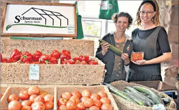  ?? DESIREE ANSTEY/JOURNAL PIONEER ?? Seabille Bergeron-Dawe, left, and Amanda Dawe sell fresh produce picked from Schurman Farm at the Summerside Farmers Market.