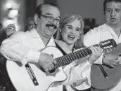  ?? Billy Calzada / Staff photograph­er ?? Carmen Yulín Cruz Soto, mayor of San Juan, Puerto Rico, sings with Antonio Rodriguez of the group El Trio Mio at the SAAHJ gala.